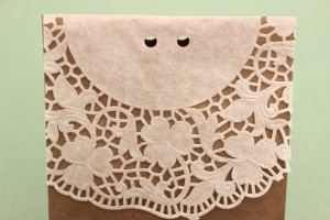 Two Holes Punched Into the Top of the Doily-Lined Paper Bag