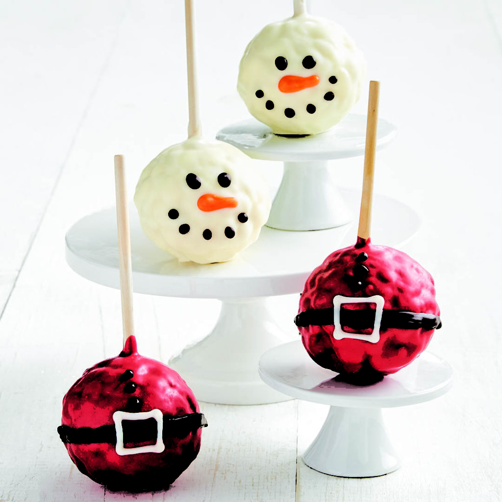 holiday popcorn balls dunked in chocolate and decorated as a cheery snowmen and Santa's belt.